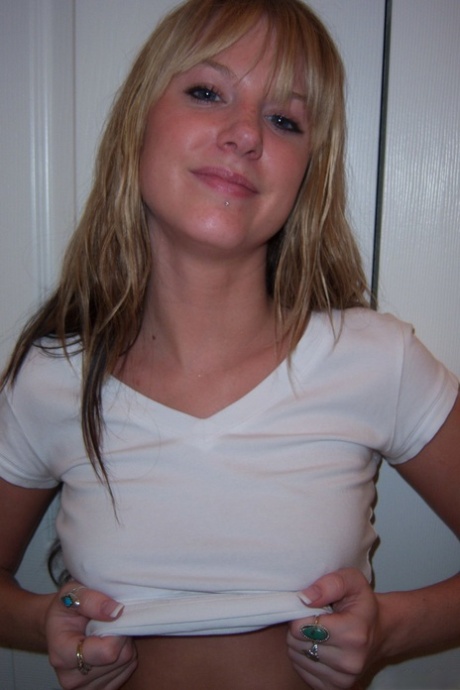Dirty blonde teen fondles her breasts while stripping to a thong 65247581